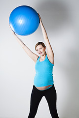 Image showing Pregnant woman exercising with fitness ball