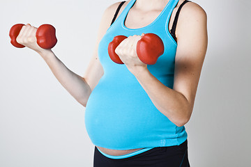 Image showing Pregnant woman exercising with dumbbells