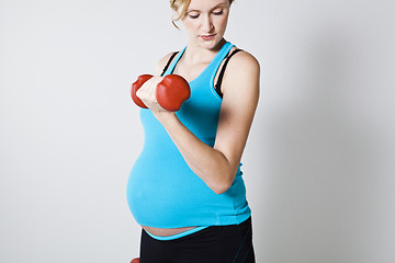 Image showing Pregnant woman exercising with dumbbells