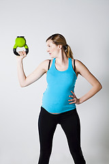 Image showing Pregnant woman exercising with kettlebell