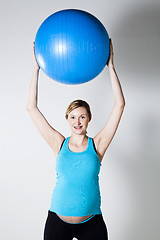 Image showing Pregnant woman stretching with fitness ball