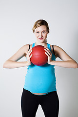 Image showing Pregnant woman holding an exercise ball