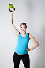 Image showing Pregnant woman exercising with kettlebell