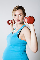 Image showing Pregnant woman exercising with dumbbells