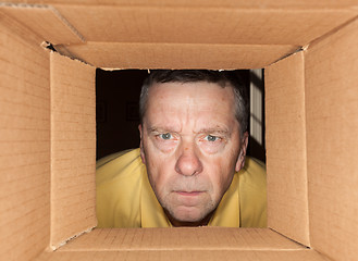 Image showing Senior man staring into cardboard box