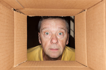 Image showing Senior man staring into cardboard box