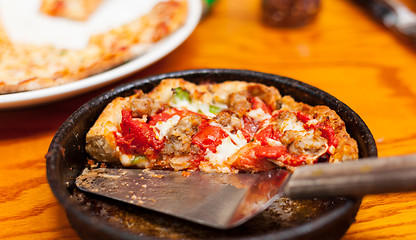 Image showing Deep dish pizza in metal serving dish