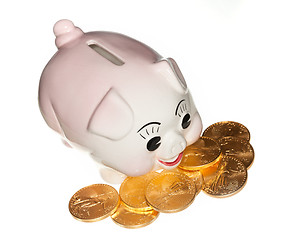 Image showing Gold coins surrounding pink piggy bank