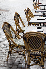 Image showing Empty cafe tables in Brussels cobbled square