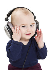 Image showing young child with ear-phones listening to music