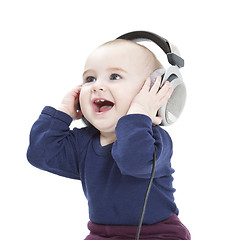Image showing young child with ear-phones listening to music