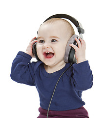 Image showing young child with ear-phones listening to music