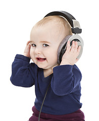 Image showing young child with ear-phones listening to music