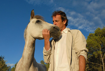 Image showing man and little horse