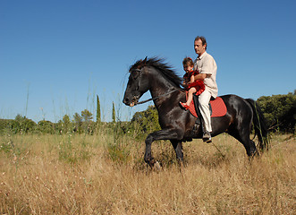 Image showing father and daughter on horse