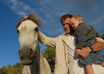 Image showing father, son and horse