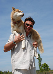 Image showing man and siberian husky