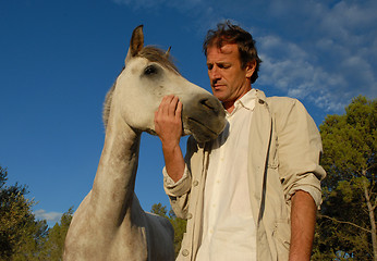 Image showing man and grey horse