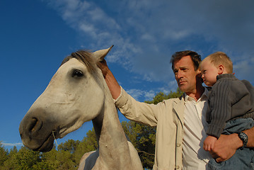 Image showing father, son and horse