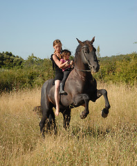 Image showing rearing stallion, teen and child