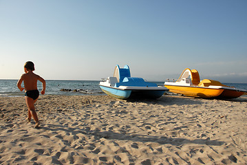 Image showing beach, boy and pedalos