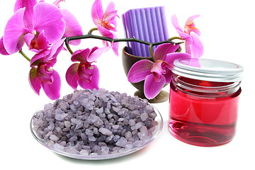 Image showing Spa concept is an orchid and a bottle of massage oil.