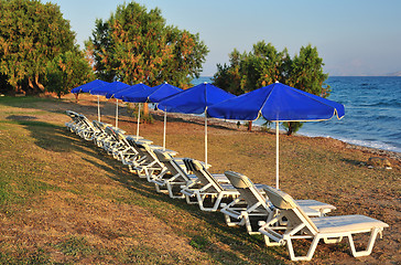 Image showing Beach with blue parasols 