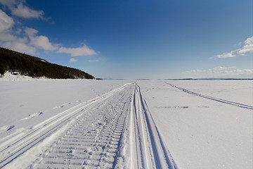 Image showing Snowmobile trail stretching into the distance