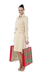 Image showing Portrait of a young woman with shopping bags