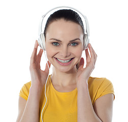 Image showing Pretty young female enjoying music