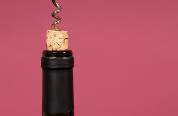 Image showing Cork being pulled out of wine bottle with a corkscrew