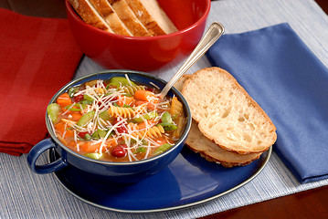 Image showing Minestrone soup in blue bowl with italian bread