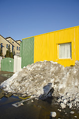 Image showing pile of melting snow in spring near building 