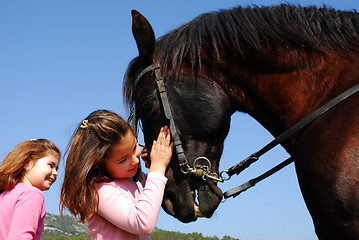 Image showing twins and horse