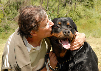 Image showing man and rottweiler