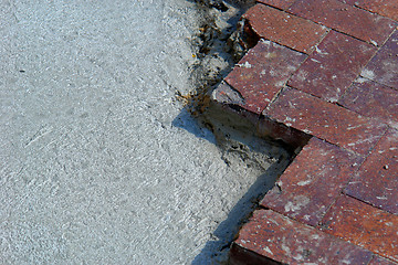 Image showing Half brick and cement background