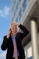 Image showing Businessman disappointed in front of a Skyscraper
