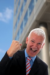 Image showing Businessman crazy in front of a Skyscraper