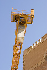 Image showing Construction Crane next to a Building