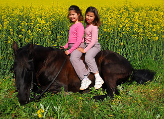 Image showing twins and horse laid down