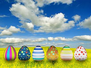 Image showing many color easter eggs over blue sky background 