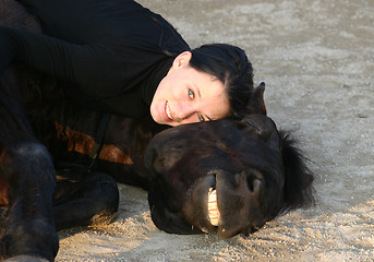 Image showing horse laid down and teen