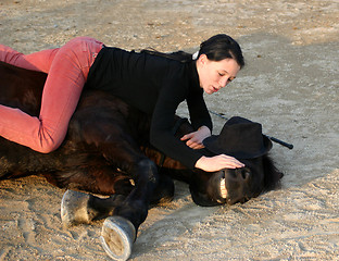 Image showing horse laid down and teen