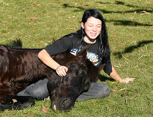 Image showing horse laid down and riding girl