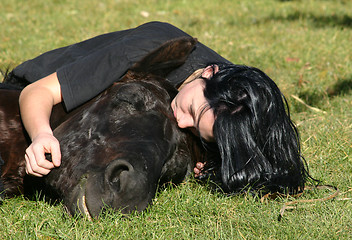 Image showing horse laid down and riding girl