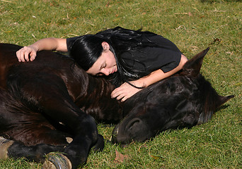 Image showing horse laid down and riding girl