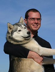 Image showing man and husky