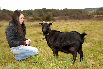 Image showing teen and goat