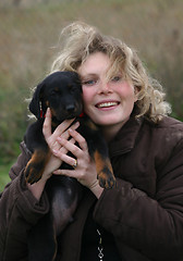Image showing puppy beauceron and woman