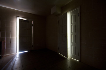 Image showing Inside a dark room with half-opened doors